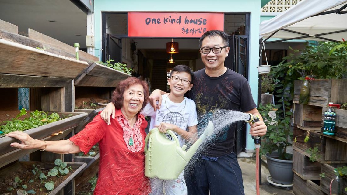 Mummy Soh and her family standing in front of their home